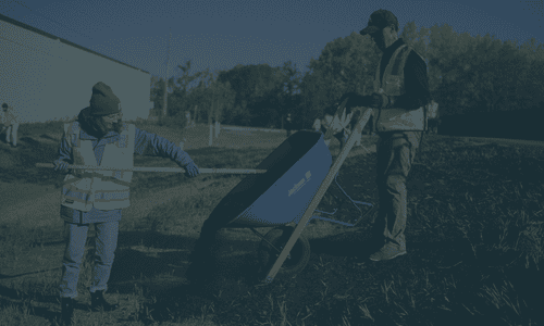 Front loader moving compost pile